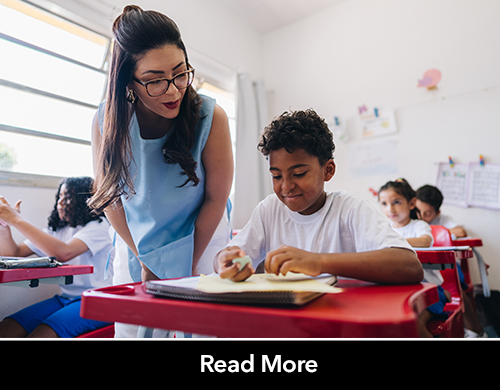 young female teacher helping a student